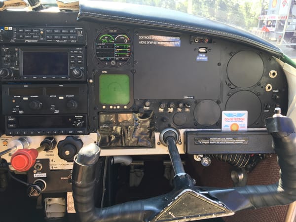 The right side of the panel: audio panel and radio stack, the green WX900 Stormscope display, and the CGR-30P engine monitor