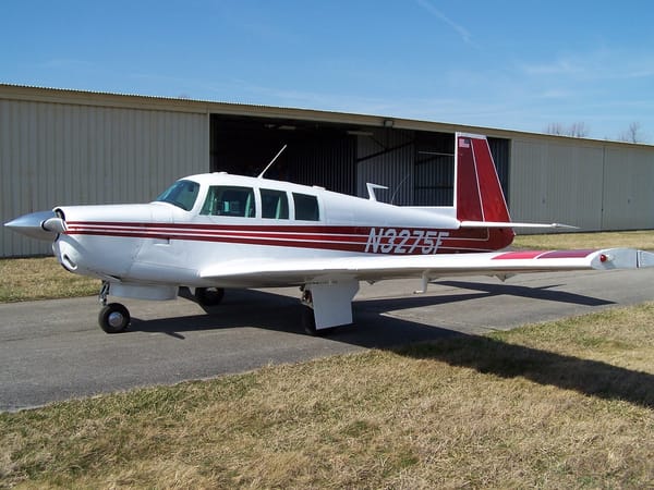N3275F parked in front of a hangar, seen from the left front